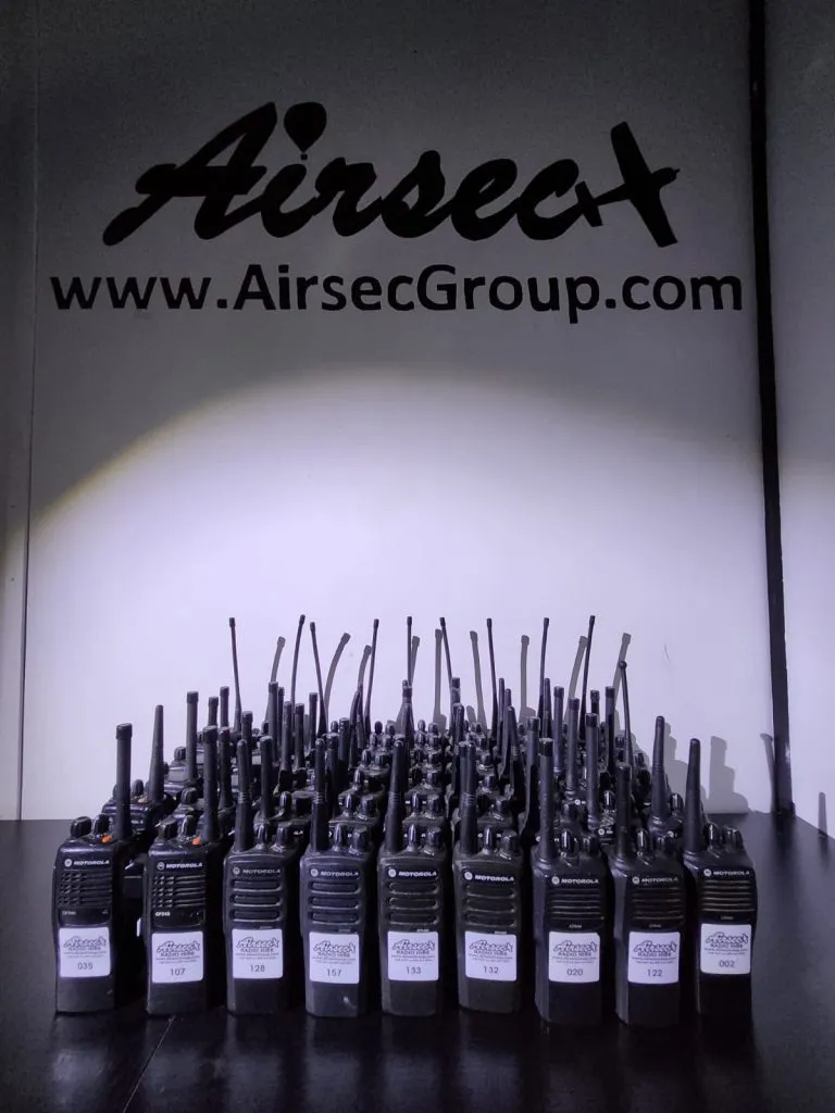Airsec Motorola radio hire fleet arranged in front of Airsec Radio Hire branding
